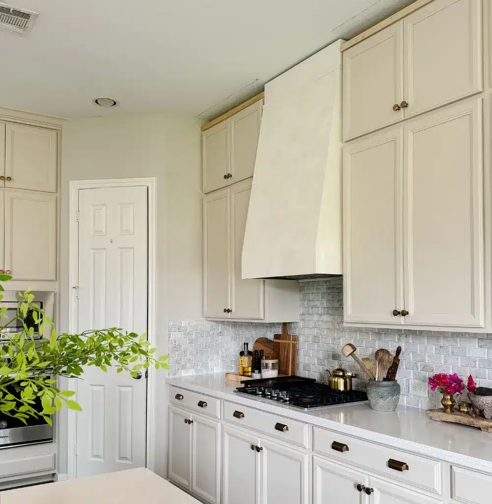 kitchen cabinet repaint project finished using white and beige tones